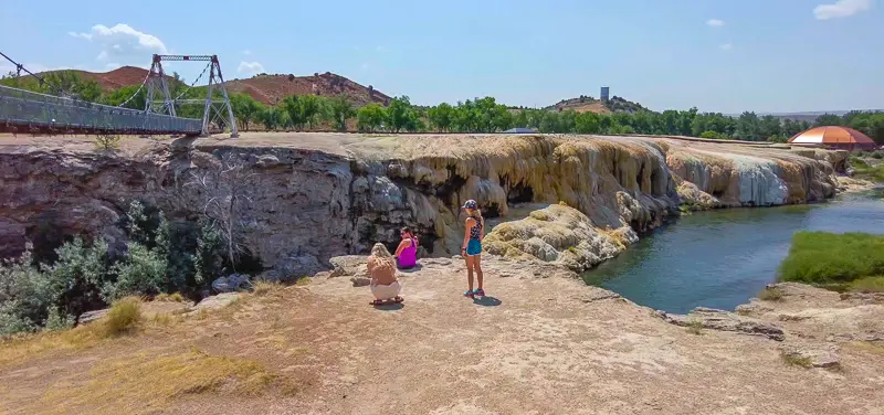 Travertine cliffs from the Hot springs in Thermopolis flow into the river during our Virtual Walk