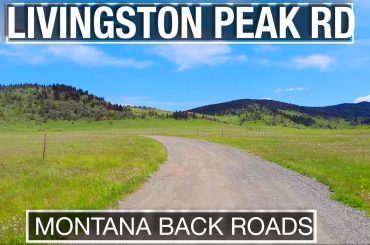 Dirt road leading through green fields into the Mountains of Montana on a virtual treadmill walk