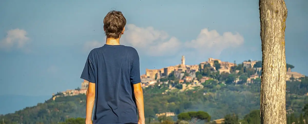 Boy looks out from the hills at Montepulciano in the distance