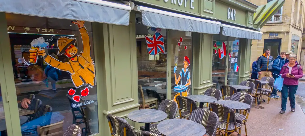 World War II cartoons painted on windows of Bayeux shops prior to anniversary of invasions in Normandy